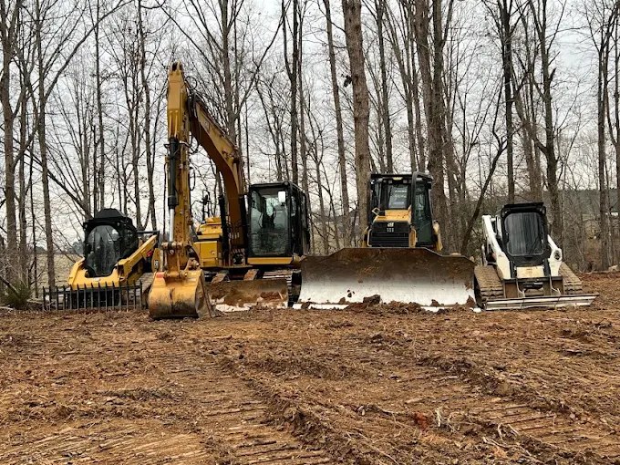 AAA Land Management excavator, bulldozer and compact equipment at a wooded site